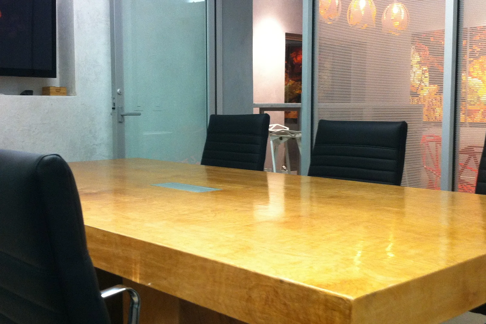 Boardroom with seating for six and wall-mounted display