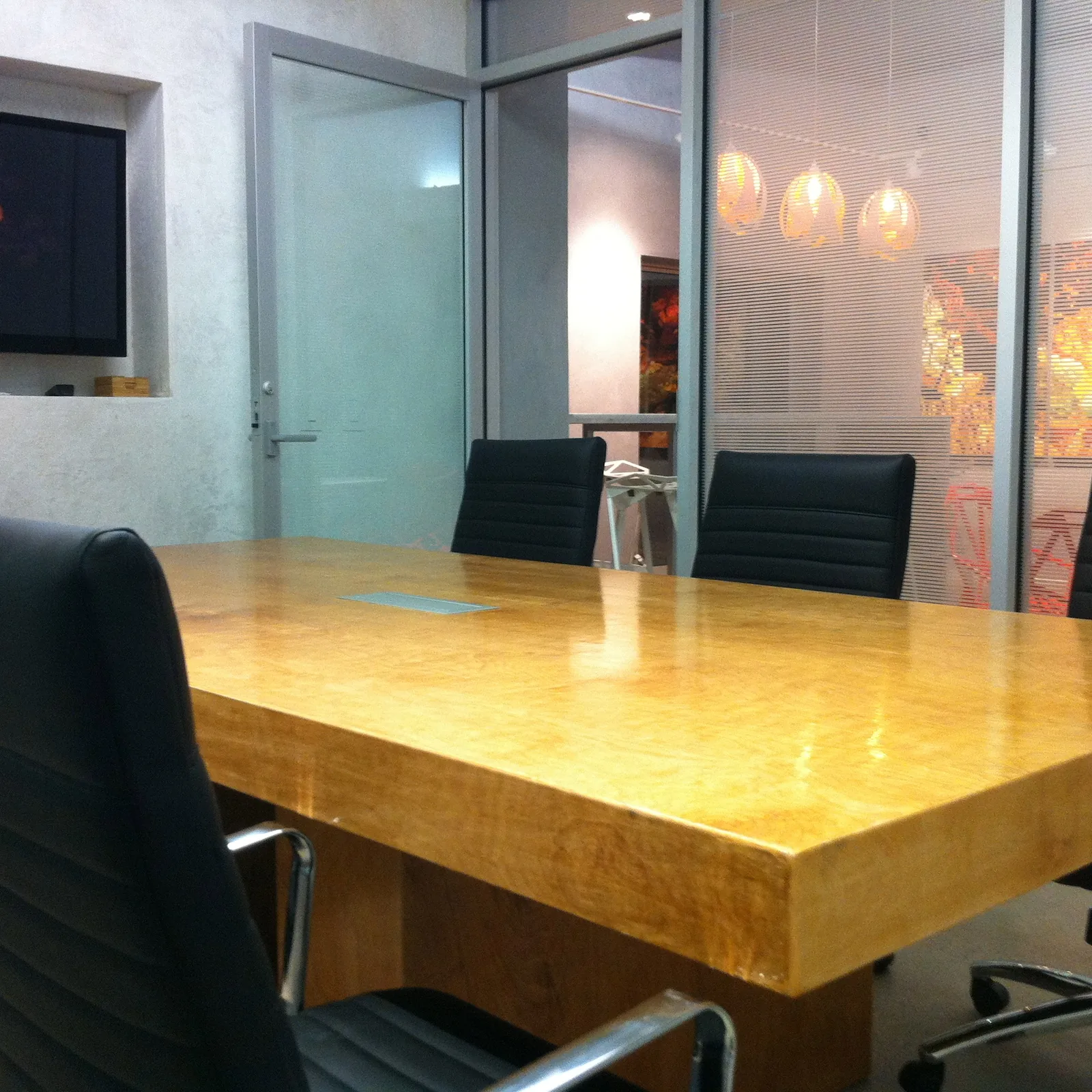 Conference room with glass wall and city artwork